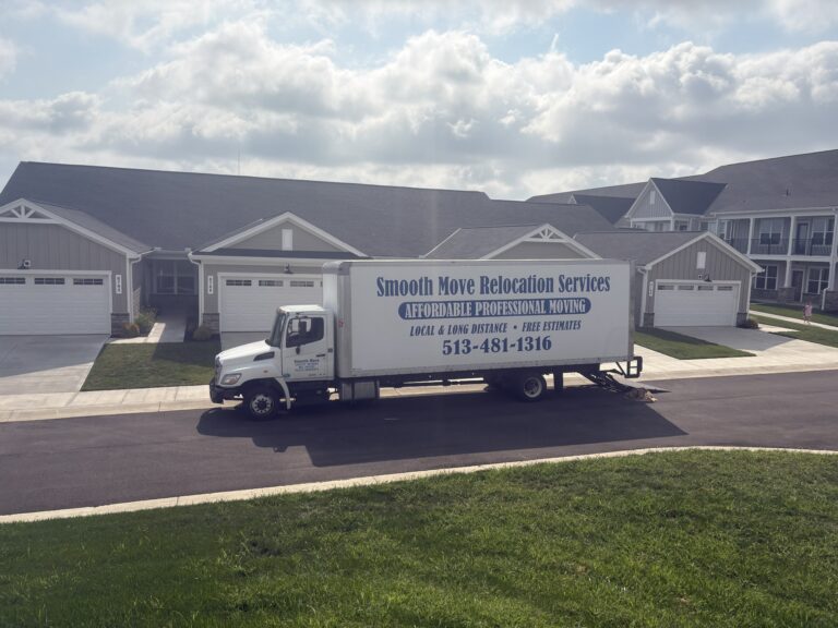 Smooth Move Relocation Services box truck parked outside a modern luxury apartment community during a residential move in the Cincinnati area, showcasing professional apartment moving services with experienced local and long-distance movers.